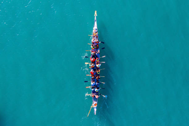 Dragon Boat team rowing to the pace of an onboard Drummer. Haifa, Israel - December 11, 2020: Dragon Boat team rowing to the pace of an onboard Drummer, Aerial view. canoe photos stock pictures, royalty-free photos & images