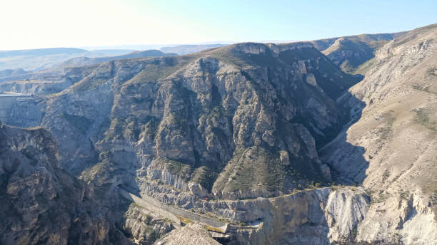 istock Ancient rocky mountains with tunnel and touristic track 1292119440