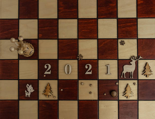 istock concept photography, new year composition on a chessboard with a queen and other pieces, 2021, Flat lay, copy space 1292120331