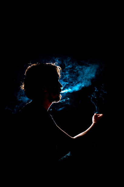 istock Colored silhouette of a smoking man 1292121063