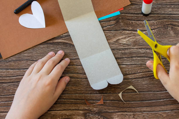 istock Instruction, step 5. On Mothers Day or Valentines Day gift - a teddy bear with a heart-card. Handmade paper ideas. Childrens creativity project, handmade, crafts for kids. 1292121736