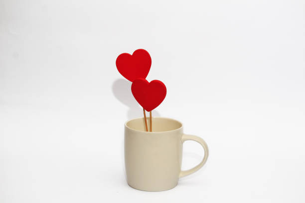 istock Red wooden hearts in a white cup on a white background 1292123103