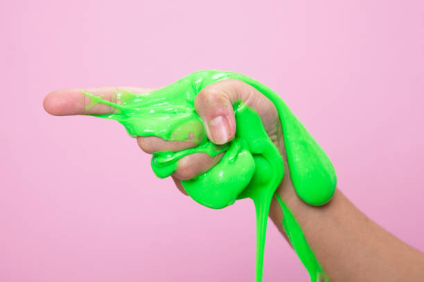 istock Hand showing somewhere with Neon pink slime toy on pink pop art backgound. 1292126752