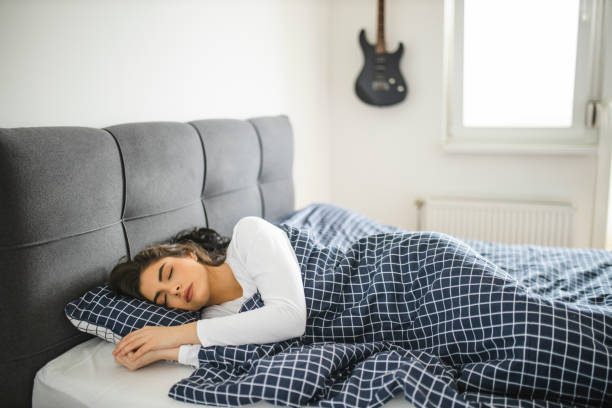 istock Peaceful beautiful lady relaxing sleeping in cozy bed 1292129617