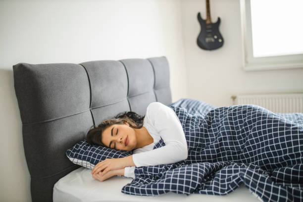istock Peaceful beautiful lady relaxing sleeping in cozy bed 1292129656