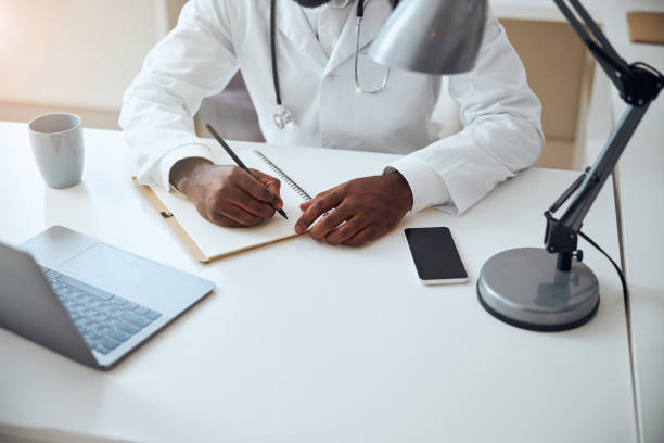 istock Hands of a medical worker holding a pencil 1292130026
