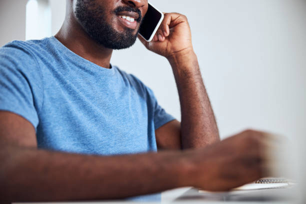 istock Smiling person is talking through a smartphone 1292130099