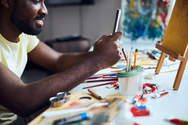 istock Mixed-race painter taking a picture with a phone 1292130184