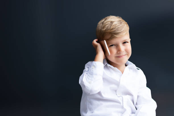 istock Cute boy talking on cell phone. 1292130870