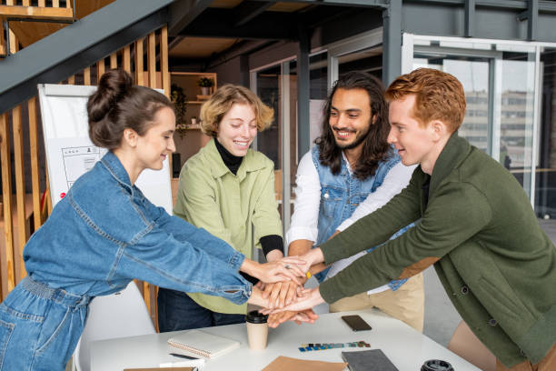 istock Happy young intercultural designers or software developers making pile of hands 1292131171
