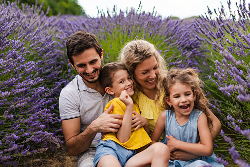 Young family enjoying on lavender field.