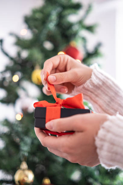 istock Female hands opening gift box. 1292136658