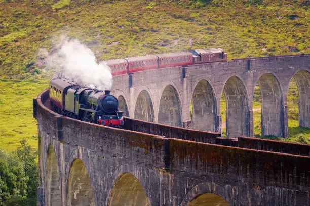 Glenfinnan railway viaduct in Scotland with the Jacobite steam train, located at the northern end of Loch Shiel of great scenic beauty, United Kingdom