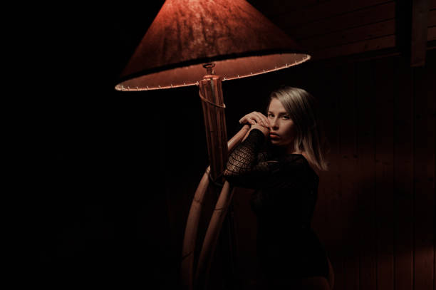 istock Blond woman at lamp posing sensually 1292138785