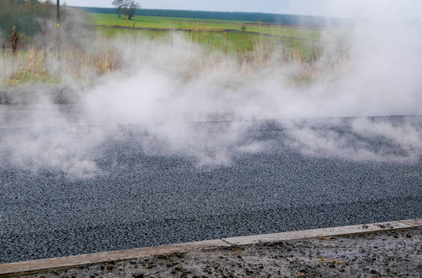 Smoking hot tarmac that has just been laid during roadworks