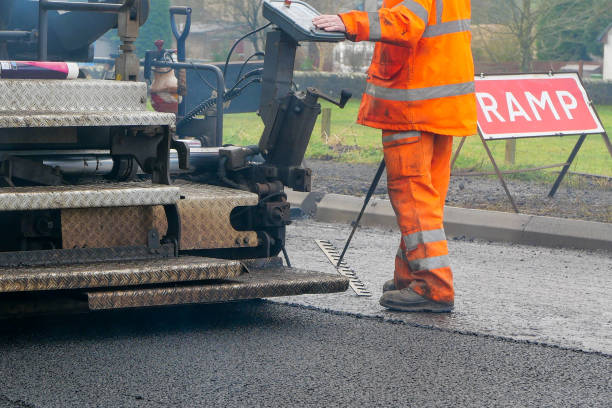 istock A construction worker walking beside machinery laying new tarmac 1292138921