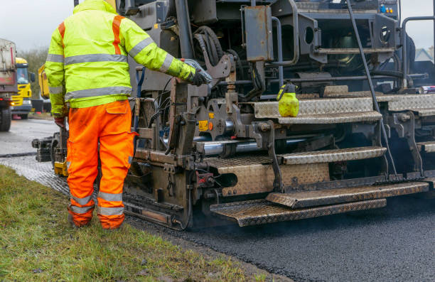istock New asphalt going down on a public road, using an asphalt paver 1292138970
