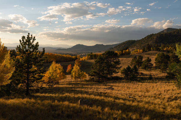 istock Sunset in the fall with mountain and trees 1292140337