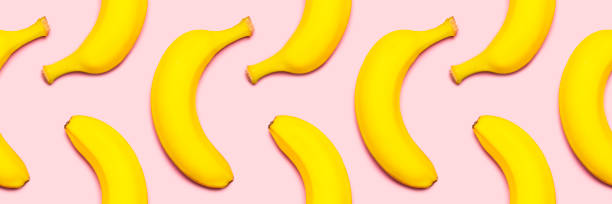 istock Seamless pattern of bananas on a pink background. 1292141917