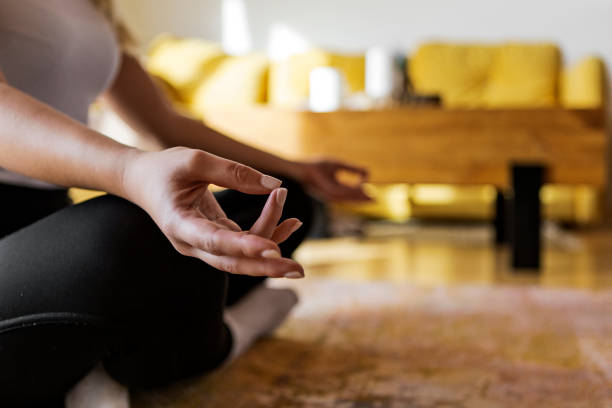 istock Unrecognizable woman sitting and meditating alone in her home 1292142694