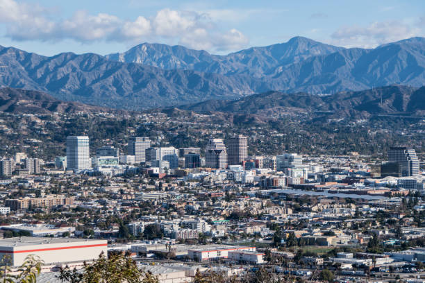 Downtown Glendale with San Gabriel Mountains in California Downtown Glendale with the San Gabriel Mountains in background.  View from hilltop at Griffith Park in Los Angeles California. eagle rock stock pictures, royalty-free photos & images