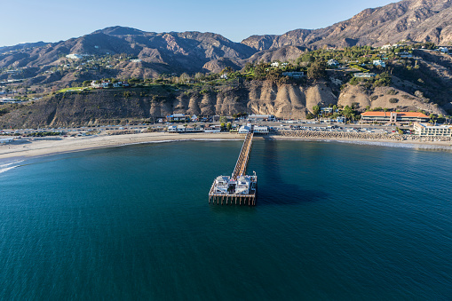 Aerial of Malibu Pier State Park and the Santa Monica Mountains near of Los Angeles California.