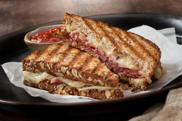 Italian Style Panini Italian Style Panini with Salami, Prosciutto, Mortadella, Brie and a Marinara Dipping Sauce prosciutto brie stock pictures, royalty-free photos & images