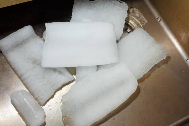 istock Large chunks of ice from the refrigerator in the sink 1292149801