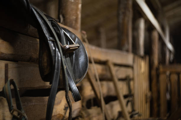 istock leather horse saddle hanging on a fence in a stable with space for text 1292155614