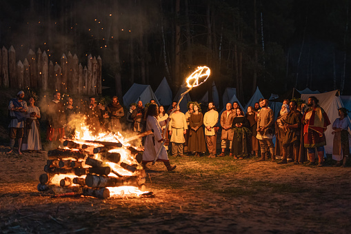 Cedynia Poland June 2019 Pagan reenactment of Kupala Night, called in Poland Noc Kupaly, shaman blessing believers with burning sign of sun. Slavic holiday celebrated on the shortest night of the year