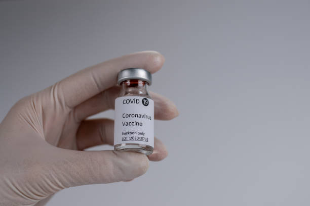 istock hand held covid 19 vaccine 1292158380
