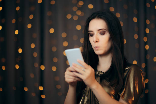 Funny Woman Receiving a Surprising Text Message Girl reacting to a spelling mistake in holiday greetings message misspelled stock pictures, royalty-free photos & images