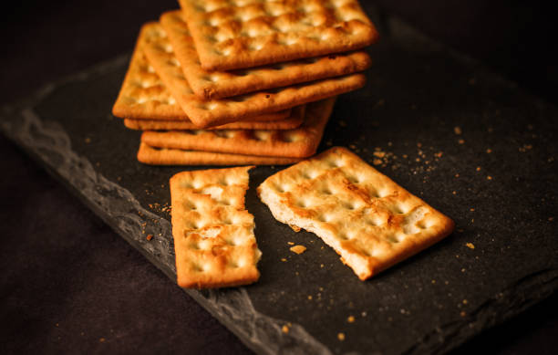 istock Salty biscuits on dark background/ salty crackers 1292170491