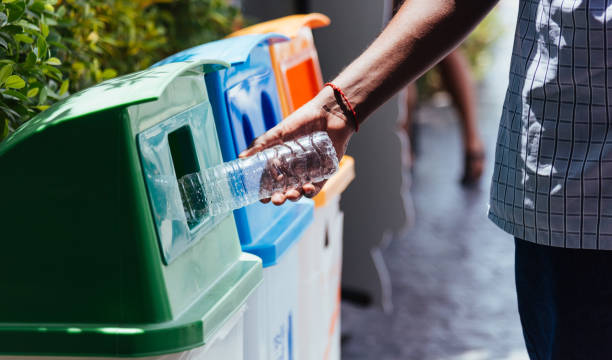 istock black hand throwing an empty plastic water bottle in the recycling garbage trash 1292172278