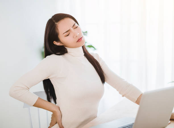 istock young woman suffering from backache after working on laptop 1292173744