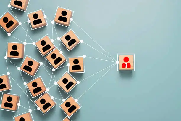 Photo of Wooden cube block print screen person icon which link connection network for organisation structure social network and teamwork concept.