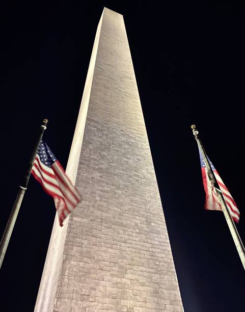 istock Washington monument and two American flags 1292179173