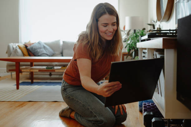 istock Woman grabs record from her record collection 1292181396