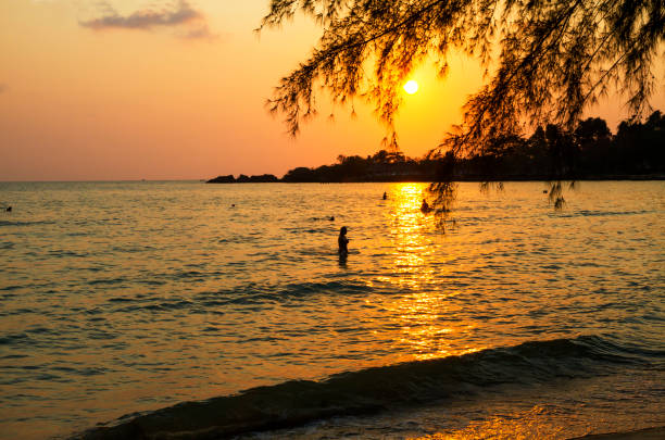 istock Sunset with black shadow of traveler at beach 1292183713