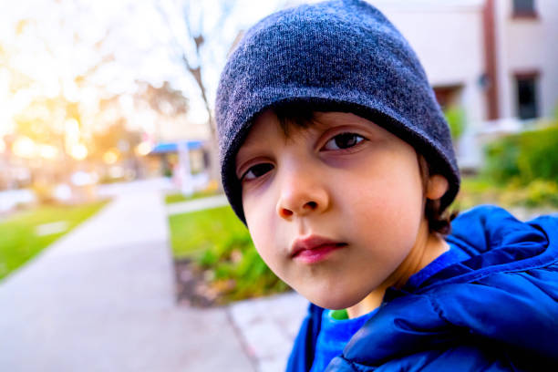 istock Serious pensive little boy looking at the camera wearing a toque hat 1292183751