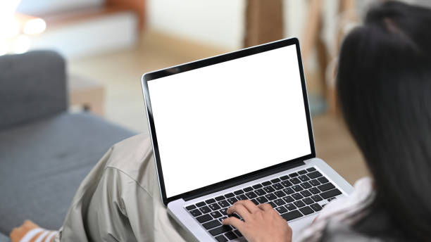 istock Young female resting on sofa and using computer laptop at home. 1292186551