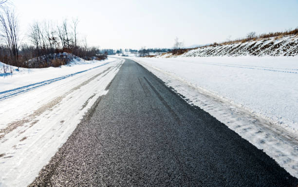 istock Country road covering with snow 1292191713