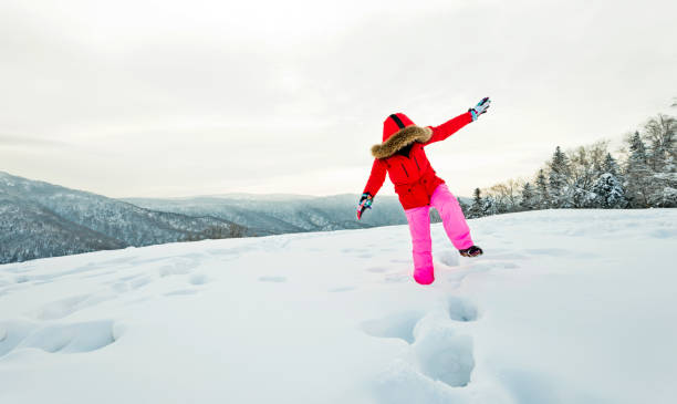 istock Woman walking through the deep snow 1292194715