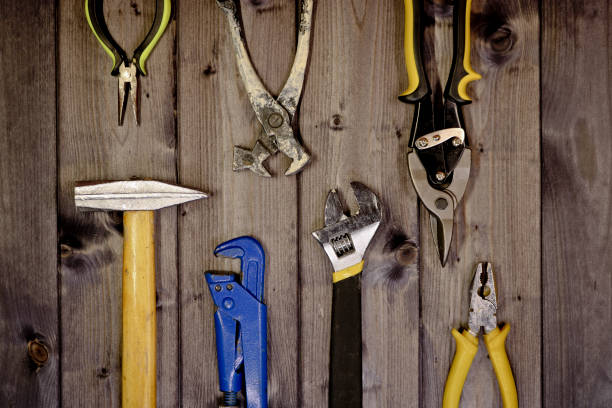 istock Set of assorted work carpentry and locksmith tools on a dark wooden background with copy space. 1292195616