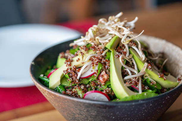 Traditional Avocado Salad with quinoa Traditional Avocado Salad with quinoa grain sprout stock pictures, royalty-free photos & images