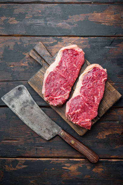 istock Veiny steak, marbled beef meat, on dark wooden background, top view 1292204860