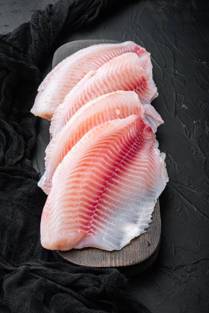 istock White tilapia fish fillet, on black background 1292205466