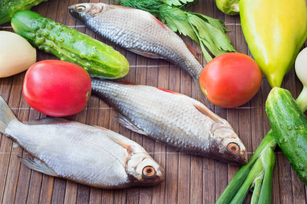 Fish and components for her preparation: vegetables, spices, parsley.