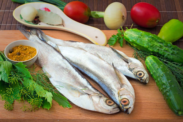 Fish and components for her preparation: vegetables, spices, parsley.