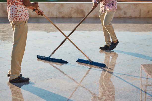 istock Low Section Of People Cleaning Tiled Floor 1292208371